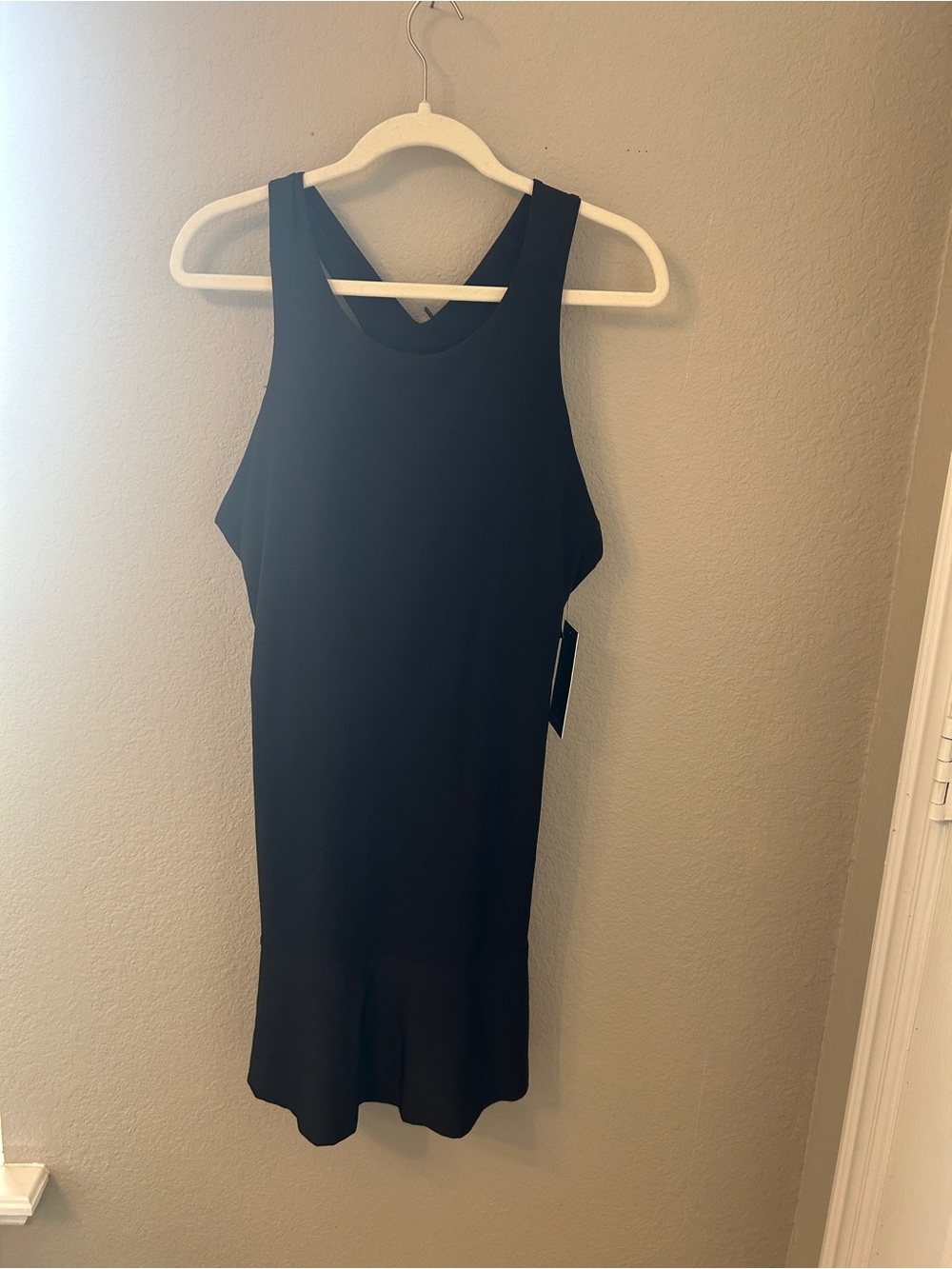 Eton Black Sleeveless Racerback Tank Dress with flounce hem.